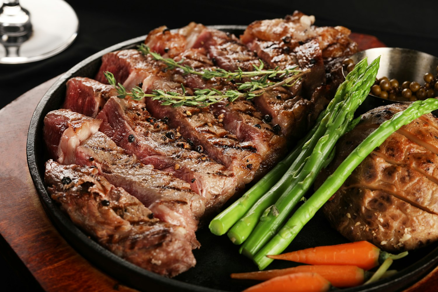 Grilled steak with charred edges, plated in a cast-iron skillet